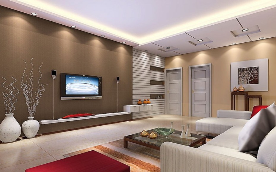 Modern living room with a white sectional sofa facing a wall-mounted TV on a brown accent wall, surrounded by decorative vases and art.