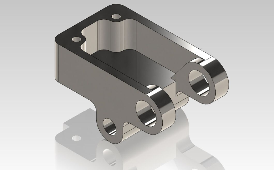 Metallic mechanical block with three through-holes and a recessed interior, shown in an isometric view.