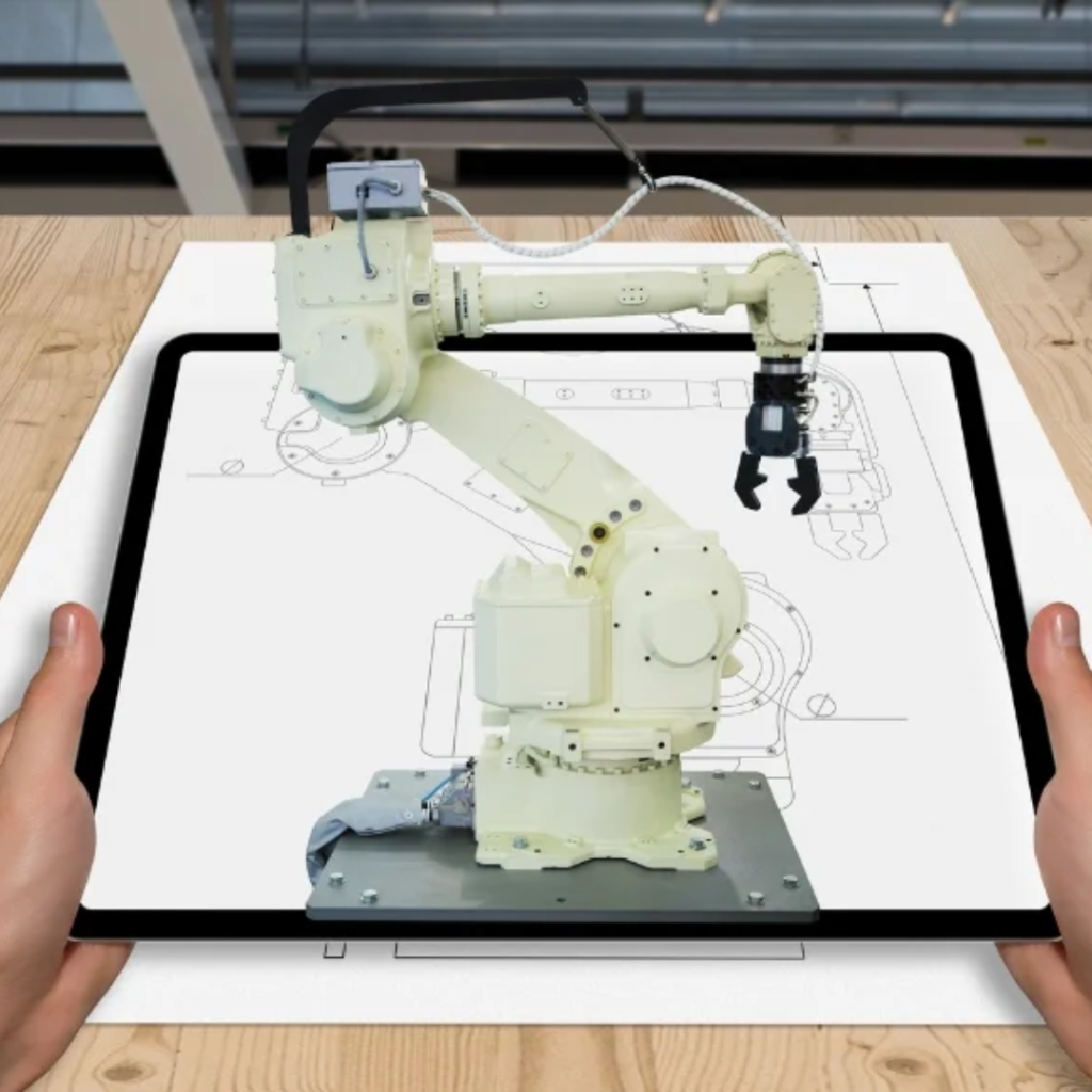 Robotic arm displayed on a tablet screen showing a technical blueprint, held by two hands.