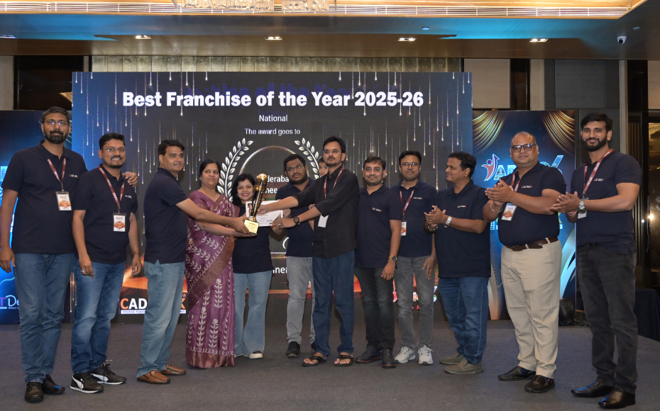 Group of people on stage receiving the 'Best Franchise of the Year 2025-26' award, with a large ceremony banner in the background showing the title and laurel design.