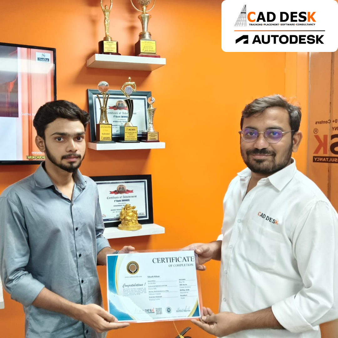 Two men exchange a certificate of completion in a bright orange office with trophy shelves; CAD DESK and Autodesk logos visible in the corner.