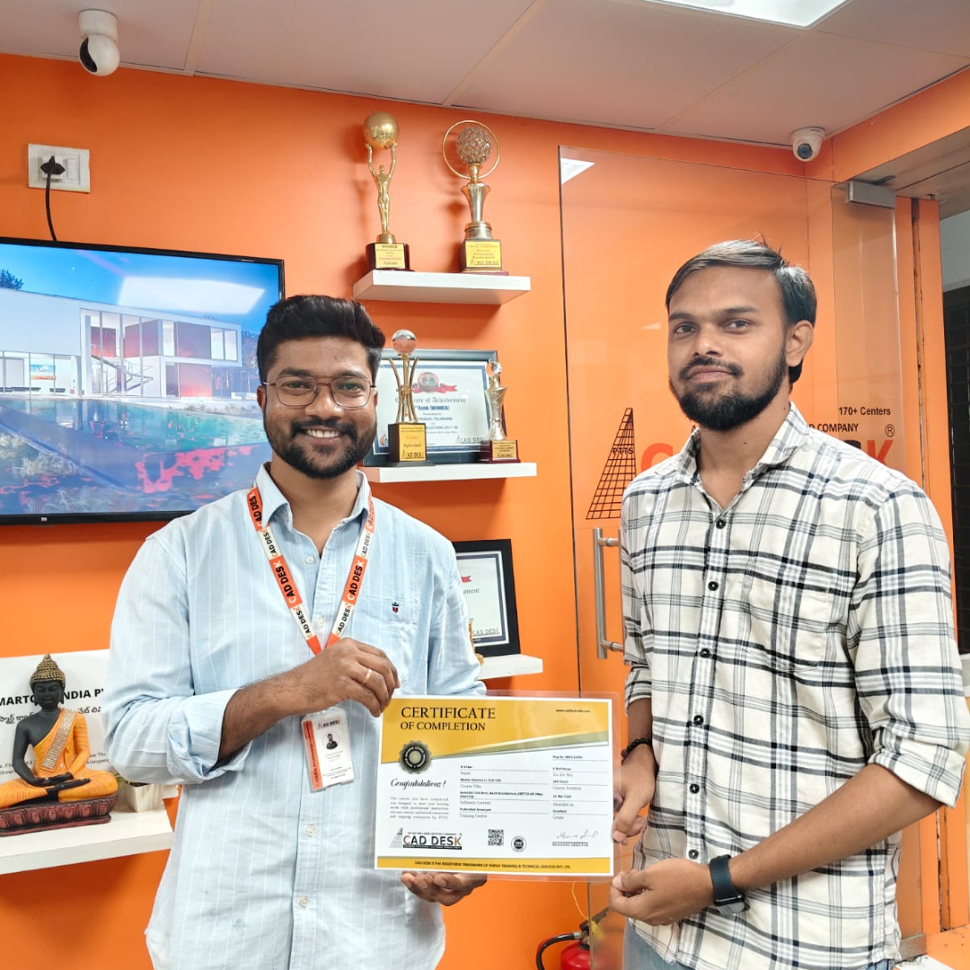 Two men in an orange trophies-filled office pose as one shows a certificate of completion to the other.