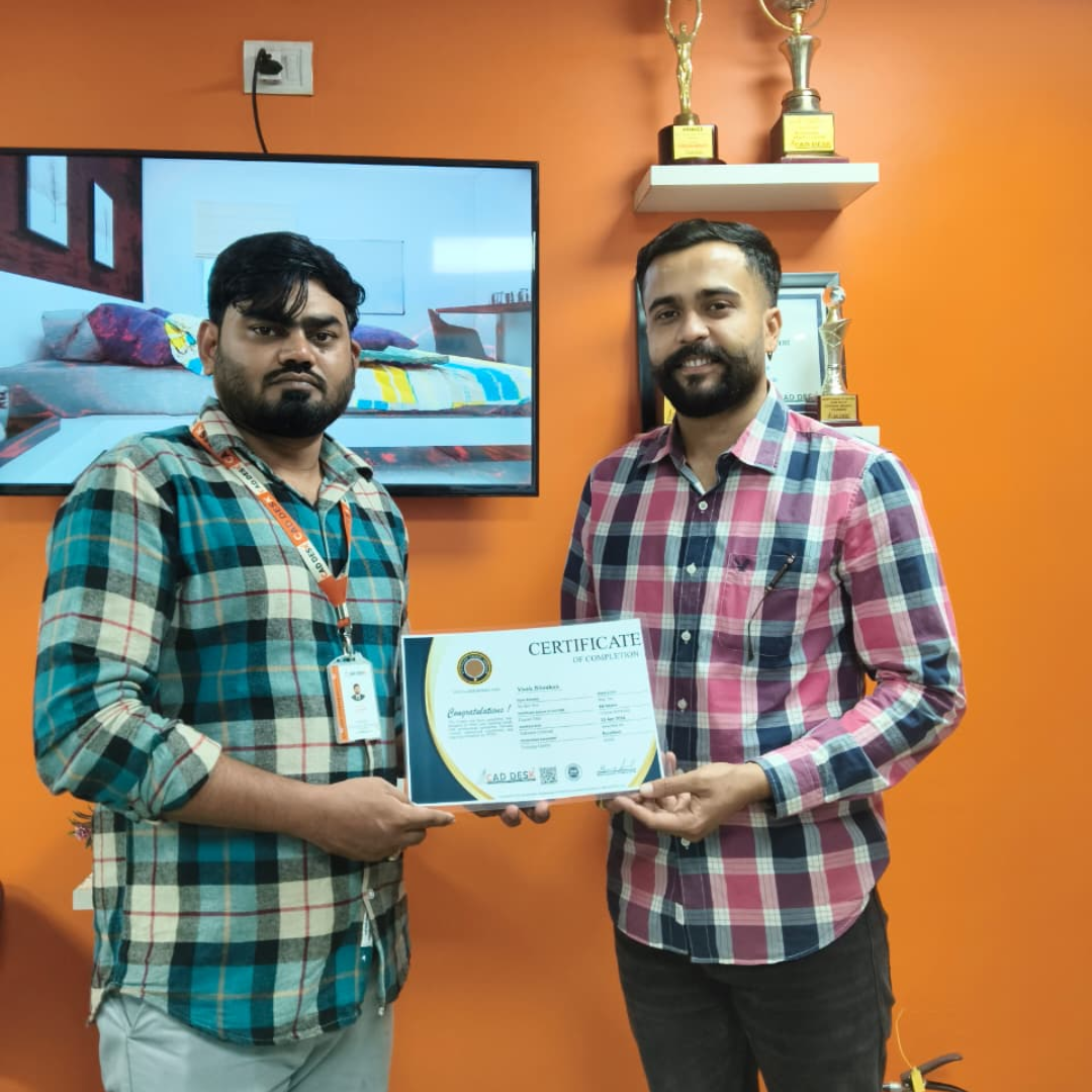 Two men in plaid shirts exchange a certificate in a bright orange room with trophy shelves in the background, both looking at the camera.