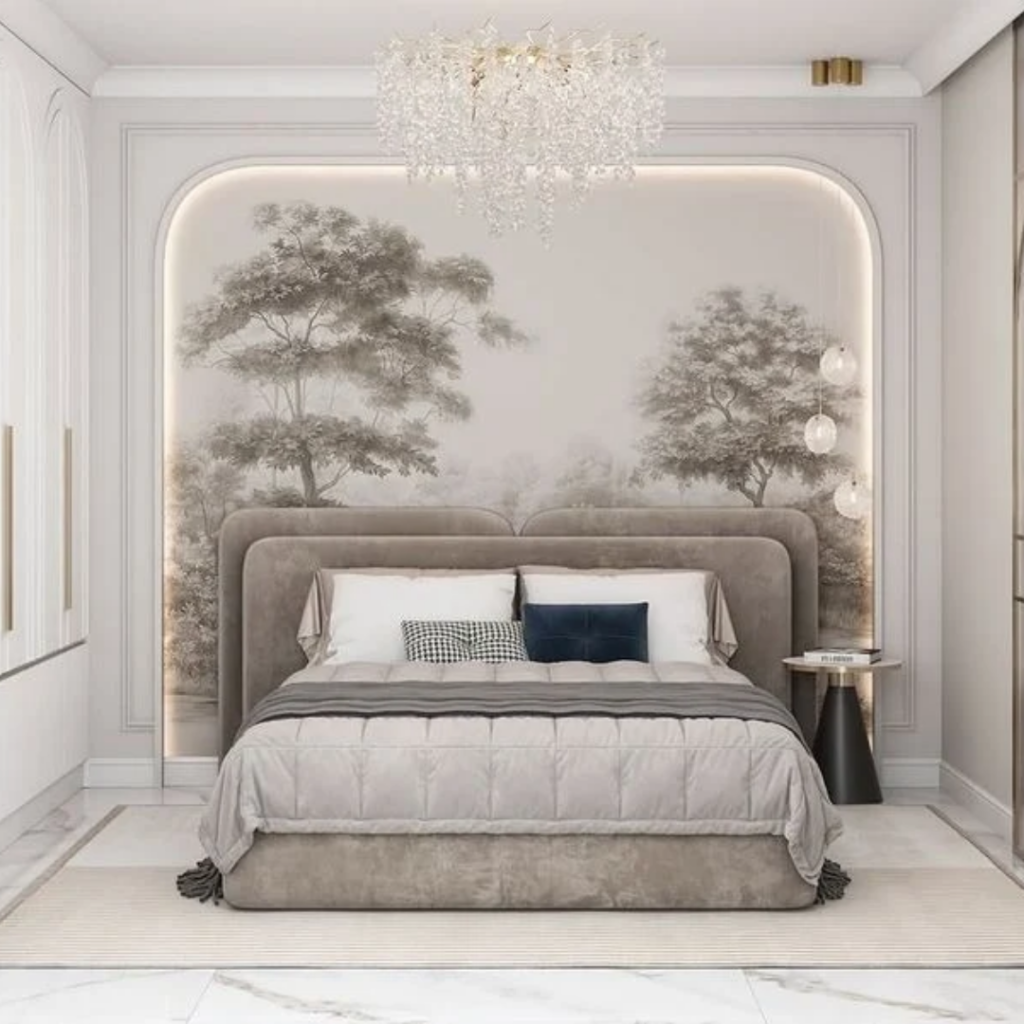 Luxurious modern bedroom with a taupe upholstered bed, arched paneling, tree mural, and crystal chandelier.